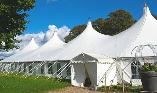 tall green portable restrooms assembled at a music festival, contributing to an organized and sanitary environment for guests in Doylestown